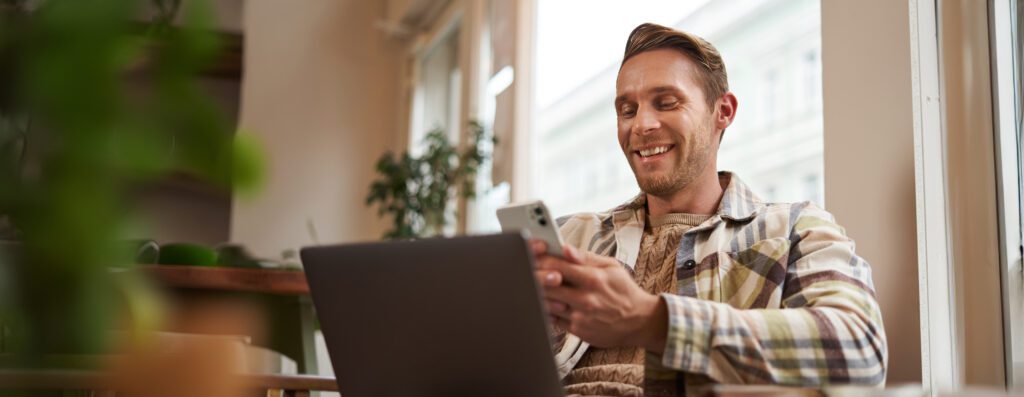 HEMPEARTH - Building the Future of Aviation — One Hemp Plane at a Time 4 close up portrait handsome smiling man with laptop cafe visitor sitting chair using smartphone